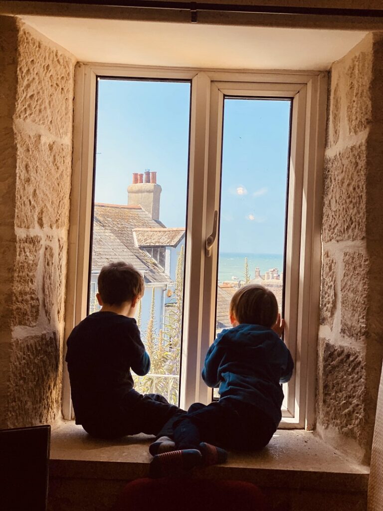 boys entranced by the view from our dorset holiday cottages by the sea